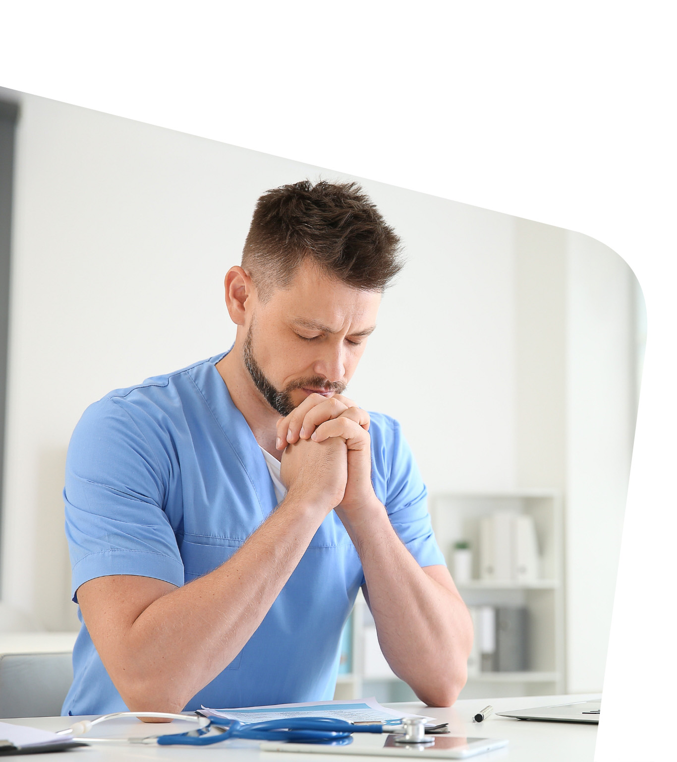 Doctor praying in clinic